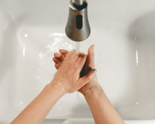 An individual washing hands with soap