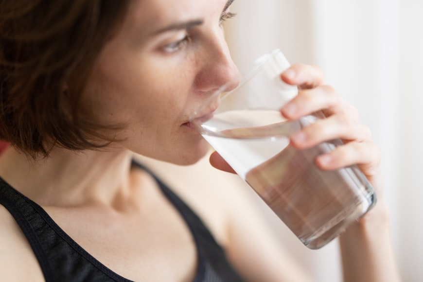 A woman drinking normal water
